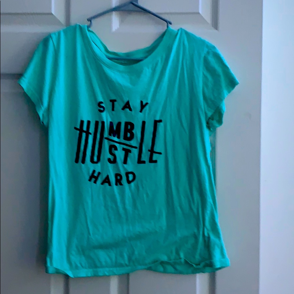 It is a cyan colored shirt with black writing